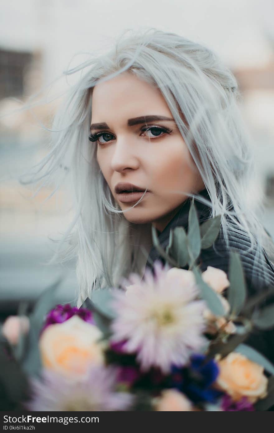 Woman Carrying Flowers Closeup Photo