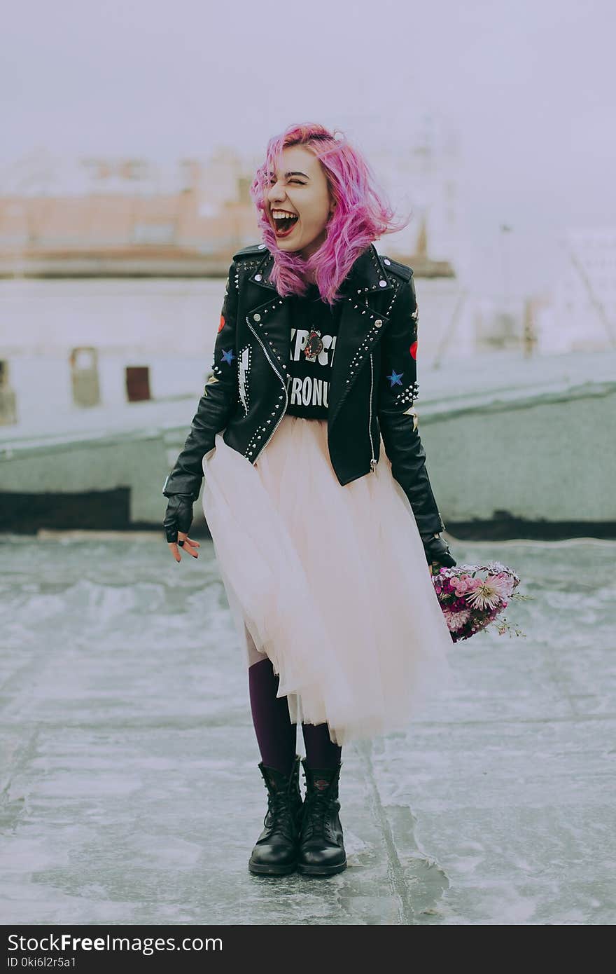 Woman Wearing Black Jacket Holding Pink Flowers