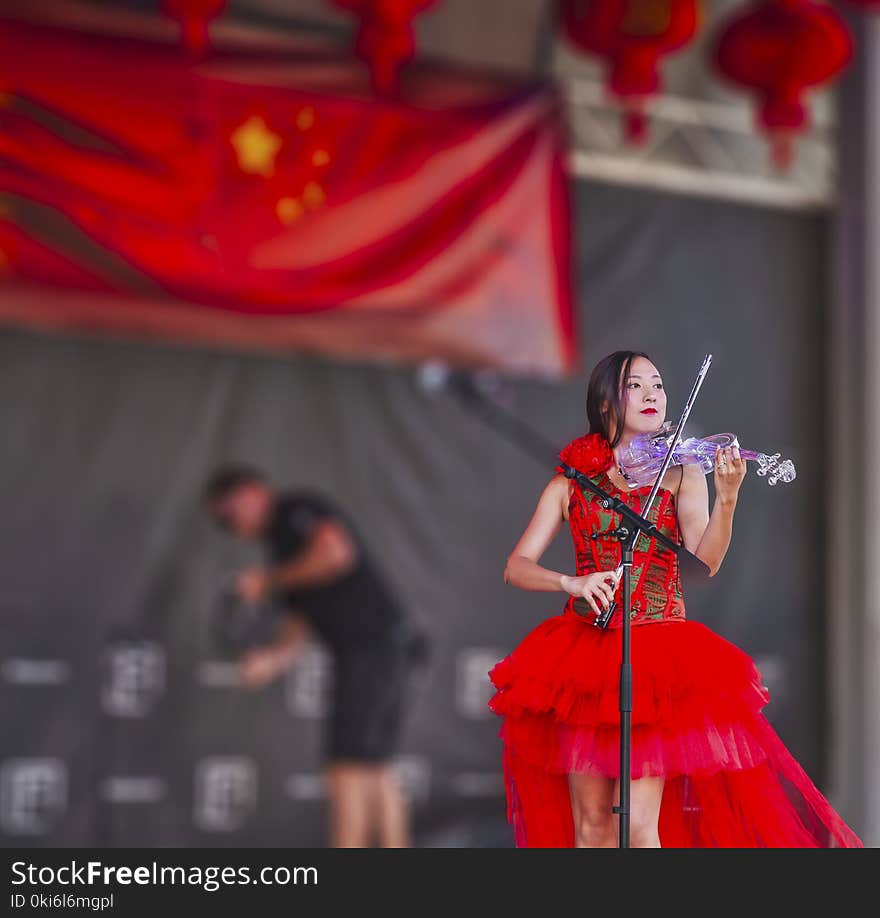 Woman Playing Electric Flying on Stage