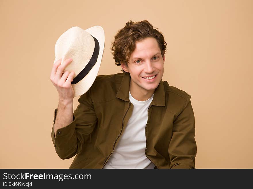 Man Wearing Brown Dress Shirt Holding White Fedora Hat