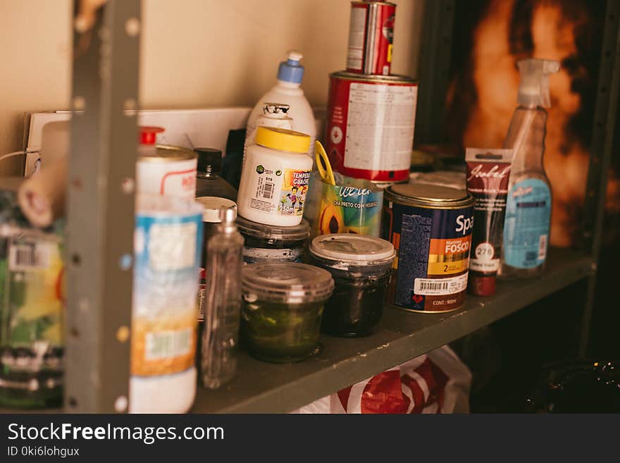 Paint Buckets on Grey Wooden Rack