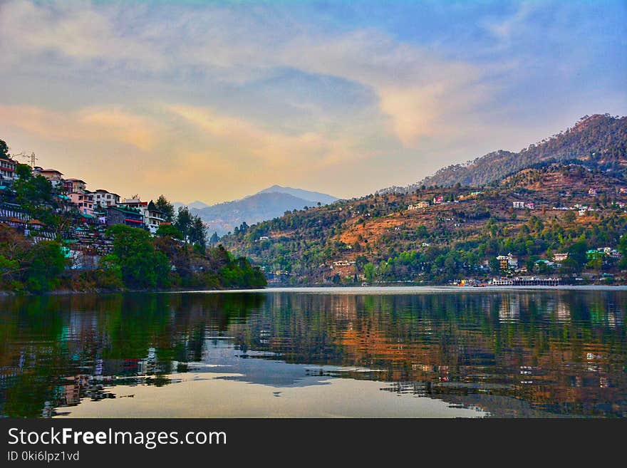 Photo of Green and Brown Mountains Under Cloudy Sky