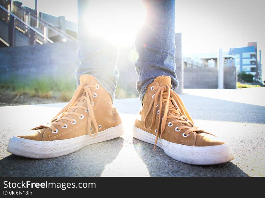 Person Wearing Brown-and-white High-top Sneakers