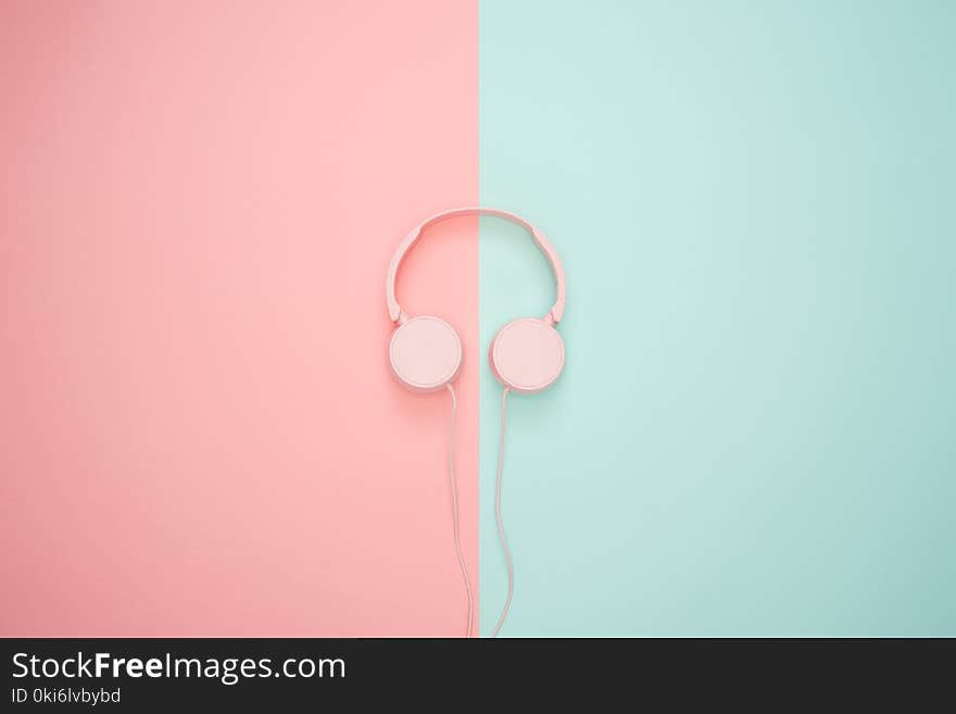 Pink Corded Headphones on pink and teal Wall