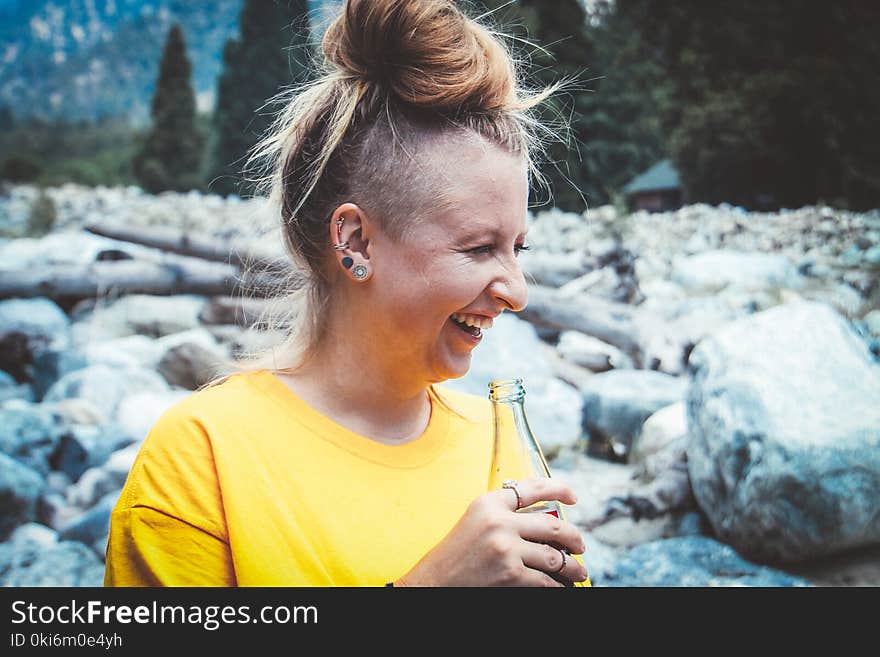 Woman Holding Glass Soda Bottle