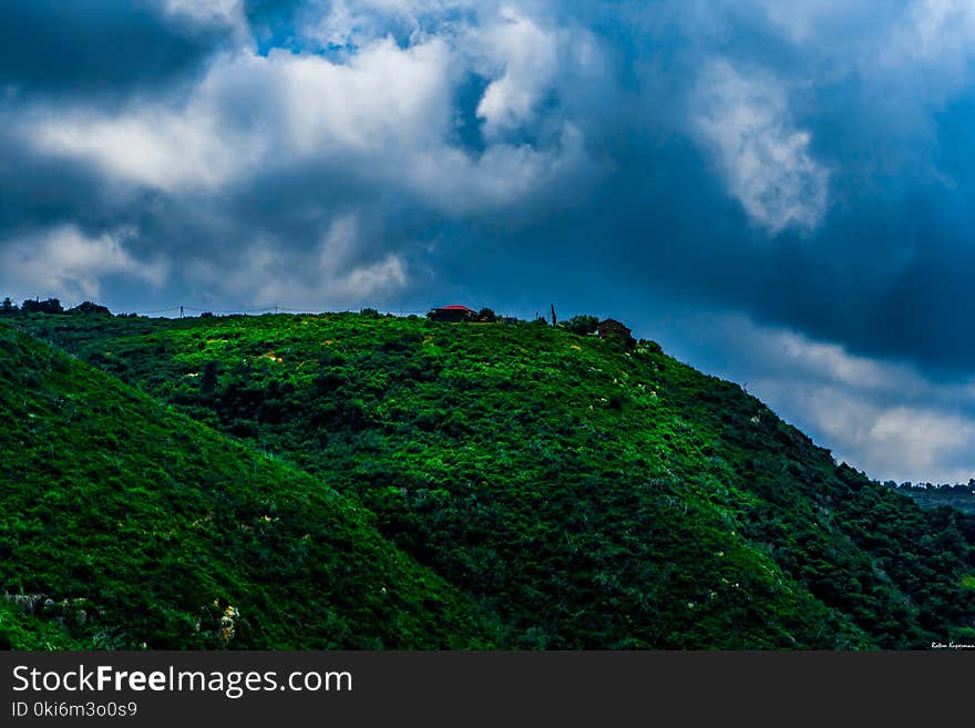 Landscape Photography of Green Mountain Under Cloudy Sky