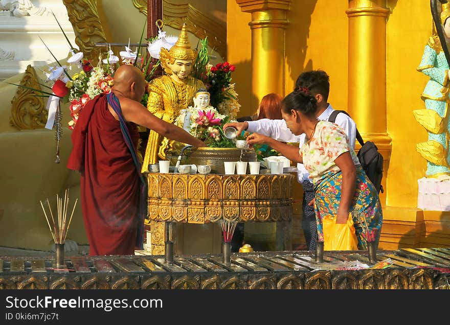 Person Pouring Water on Cup