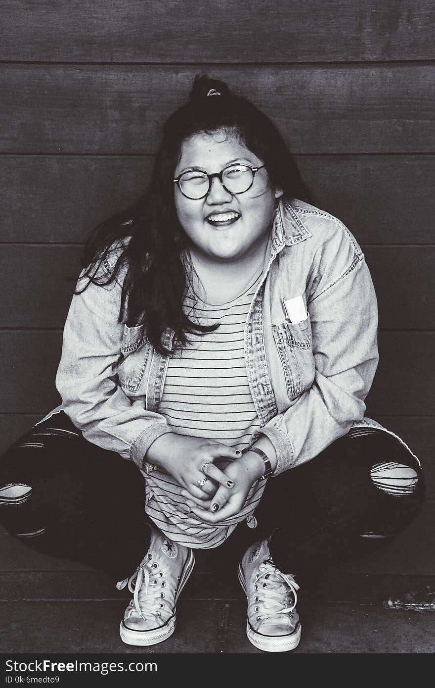 Grayscale Photo of Woman Squat Sitting