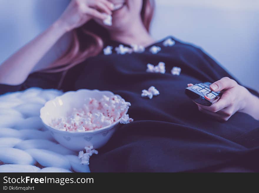 Woman Wearing Black Dress Shirt Eating Popcorn