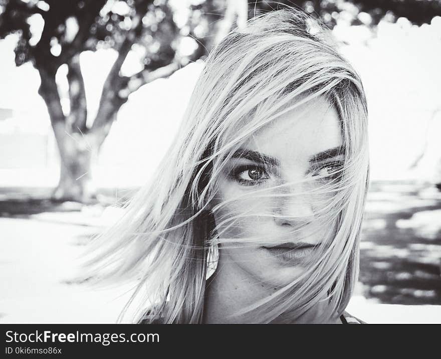 Grayscale Photo of Woman Near Tree