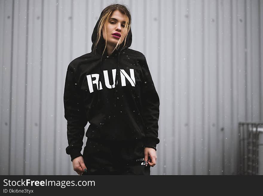 Woman Wearing Black and White Run-printed Pullover Hoodie