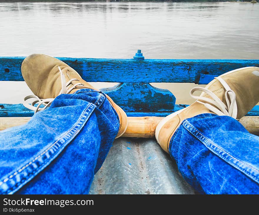 Person Sitting Near Body of Water