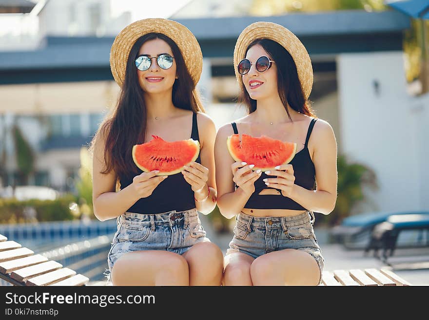 Two girls eating watermelon