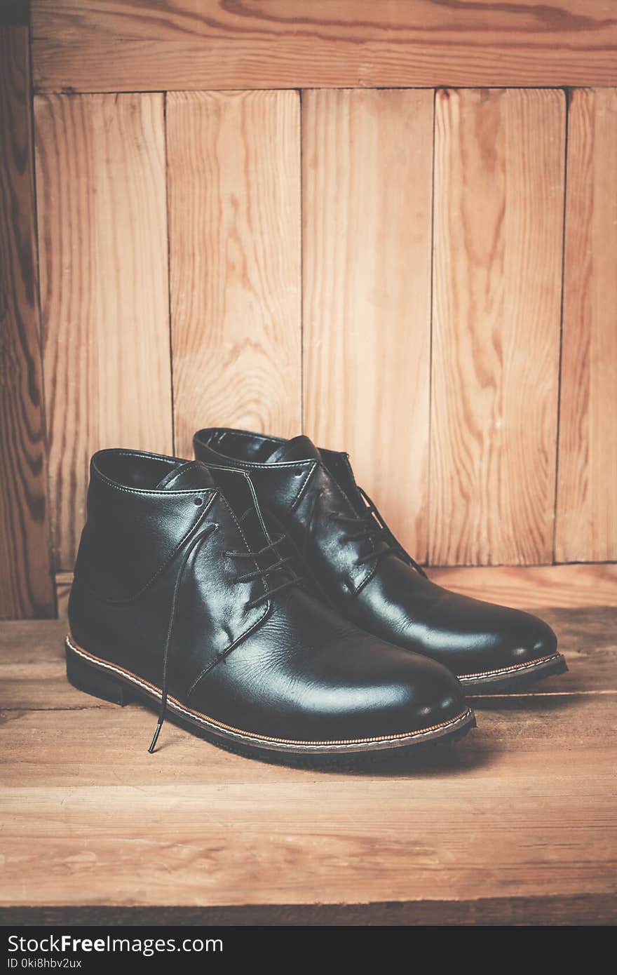 Men’s footwear on the wooden background.