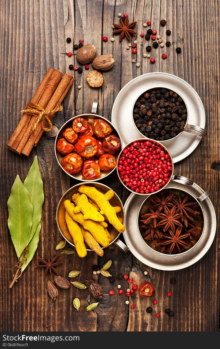 Spices in metal bowls on a wooden board