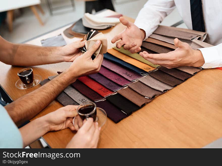 The Seller Shows Samples Of Materials For Furniture.