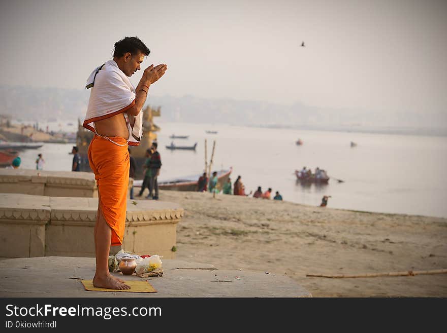 Man Meditating On Seashore