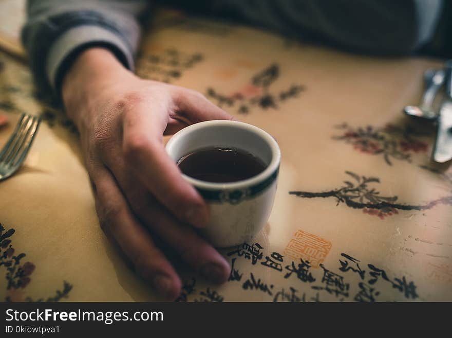 Person Holding White Ceramic Mug