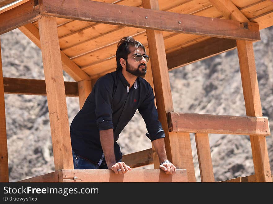 Man in Black Dress Shirt Standing in Shed