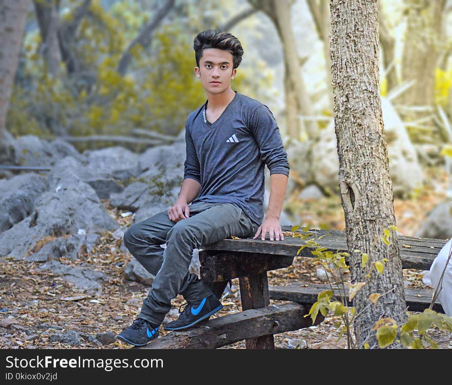 Man Sitting On Wooden Table