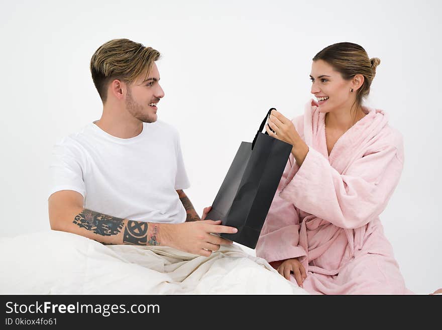 Man and Woman Holding Black Tote Bag