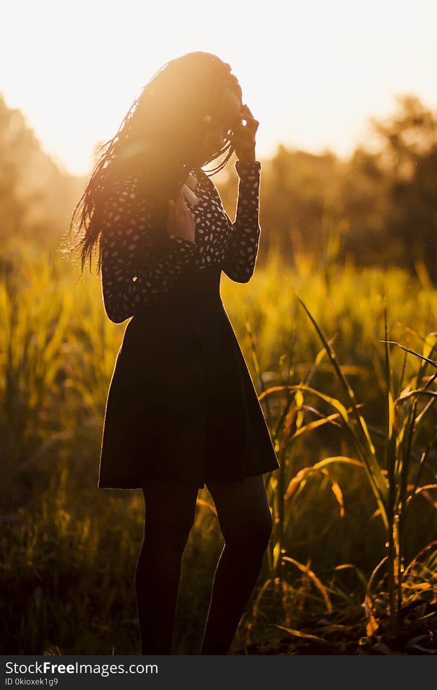 Woman Wearing Black Dress during Sunset