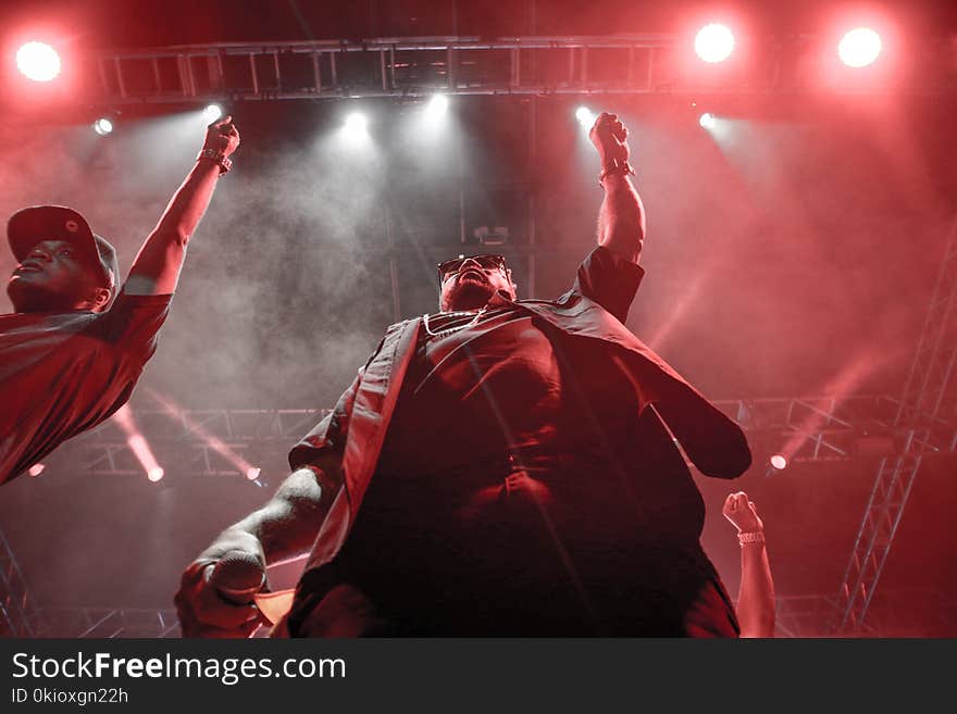 Two Men Standing Raising Right Hands