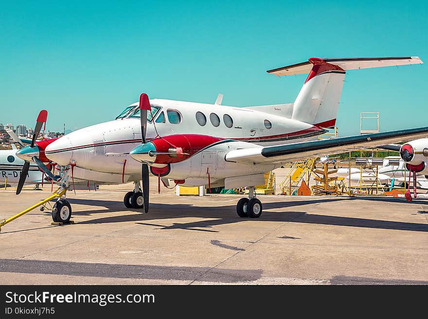 White and Red Plane Land