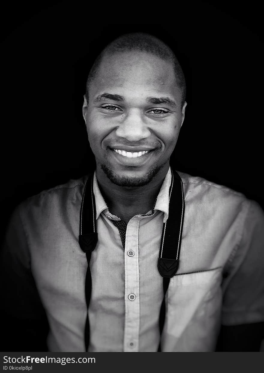 Grayscale Photo of Man With Camera Sling on Neck