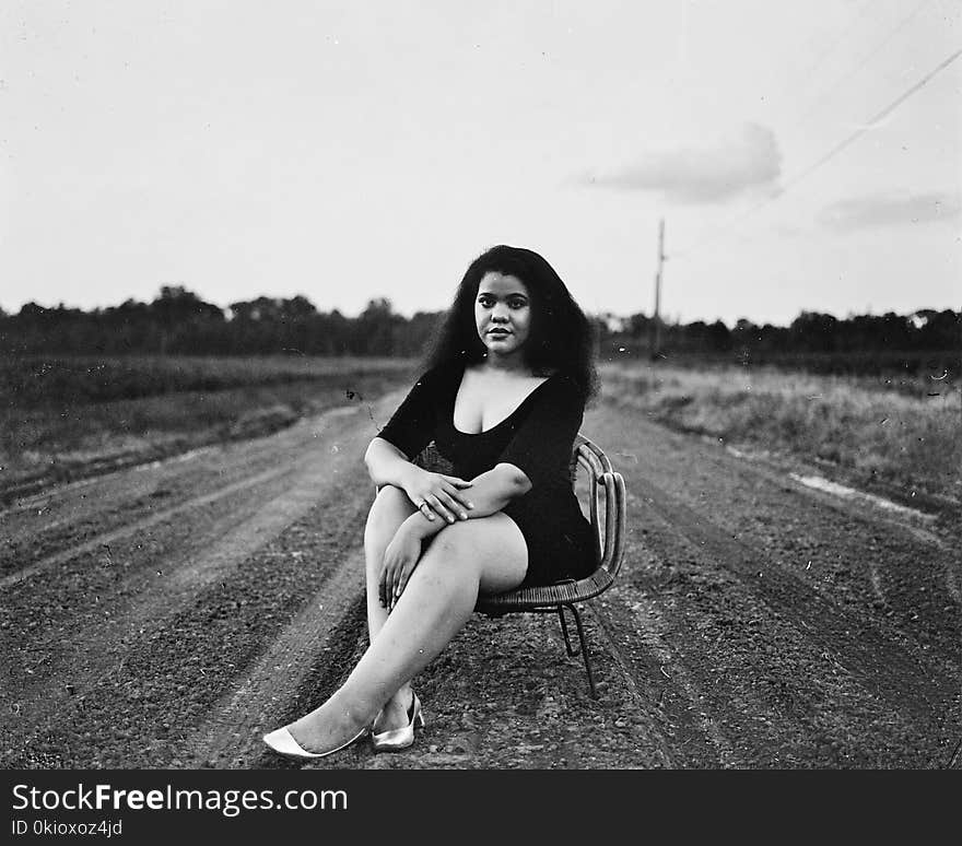 Grayscale Photography of Woman Sitting on Chair