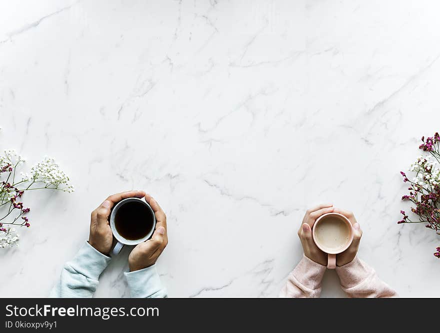 Person Holding Mug on Table