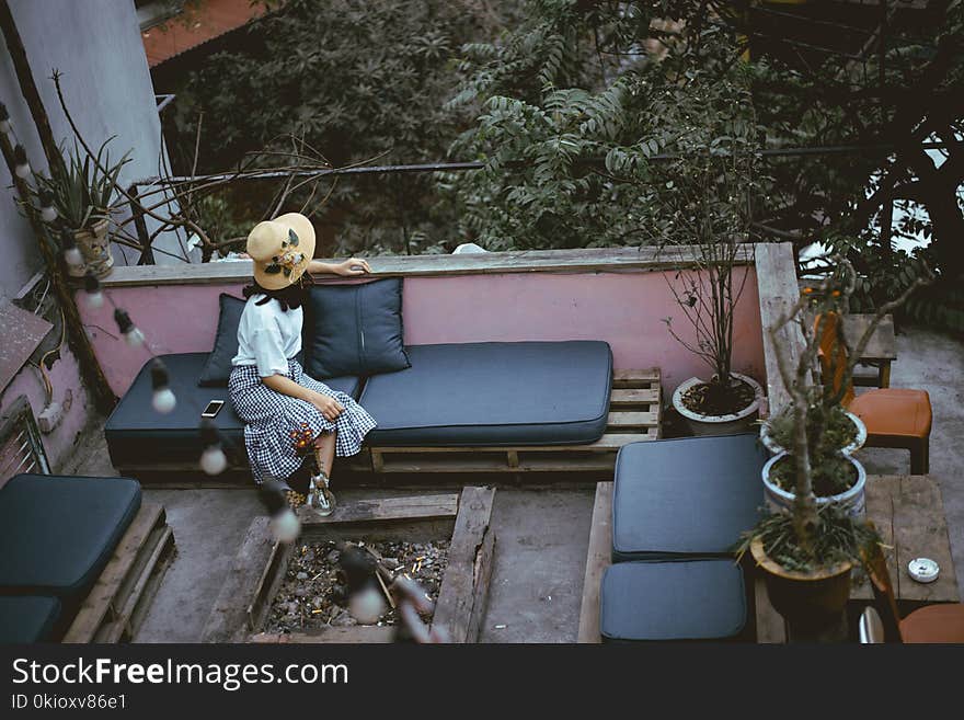 Woman Sitting on Black Leather Padded Chair