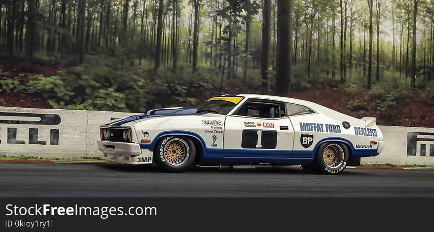 White and Blue Coupe on Road