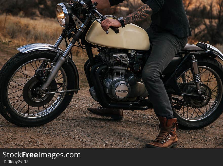 Man Riding Beige Naked Motorcycle