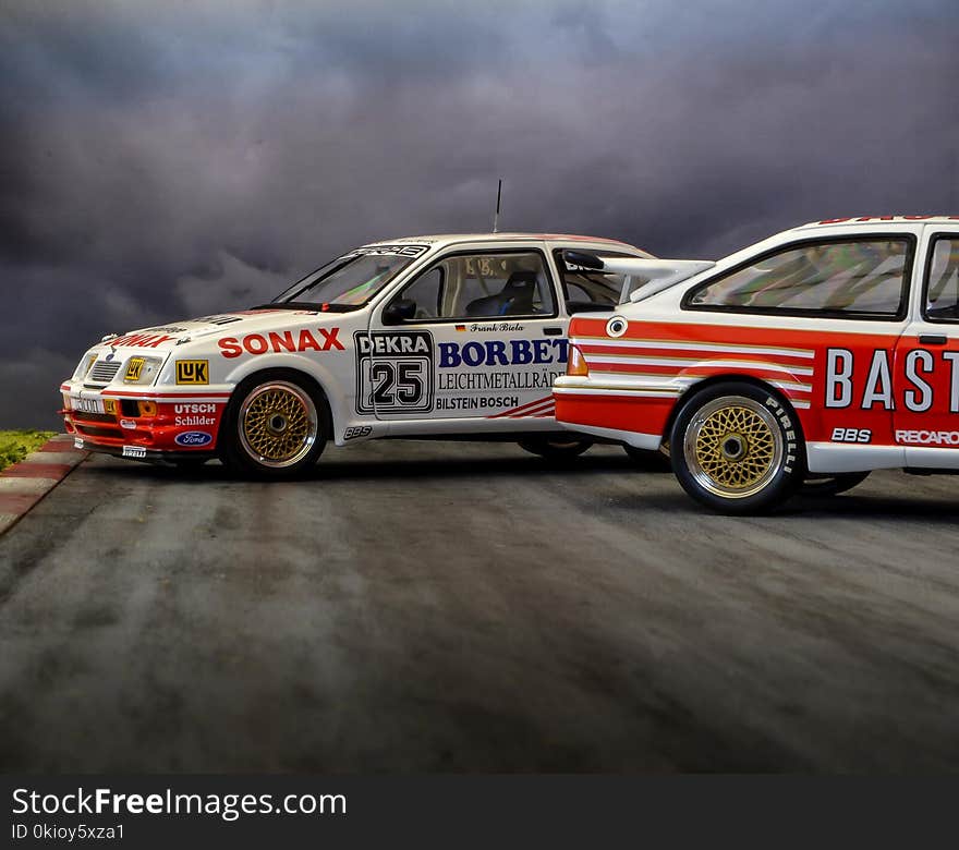 Photo of Two White-and-red Race Cars