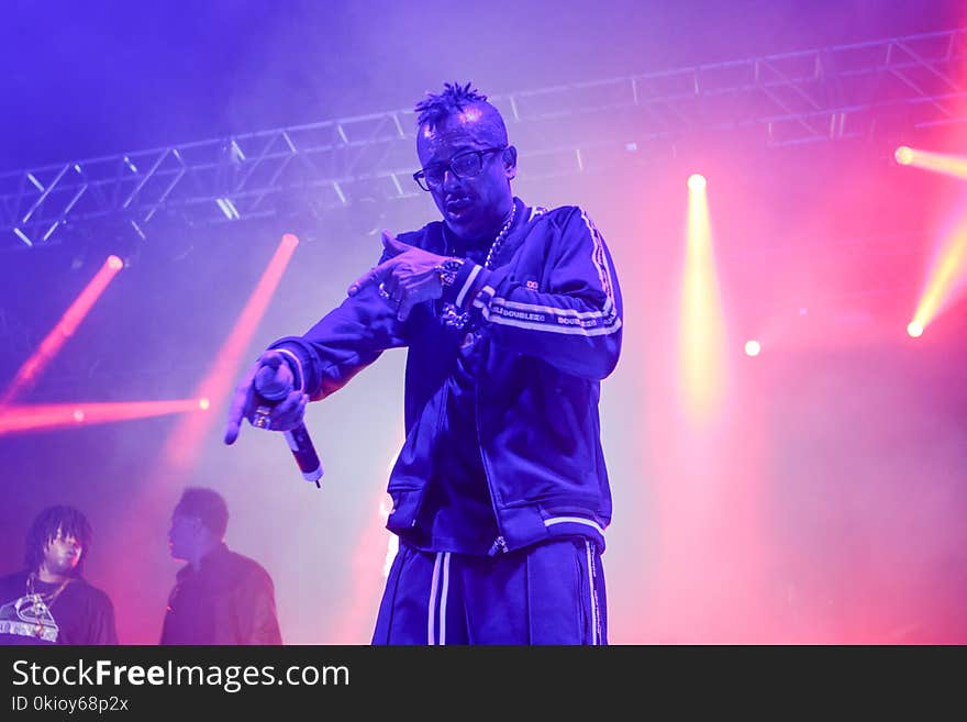 Man Wearing Zip Jacket Having Concert on Stage