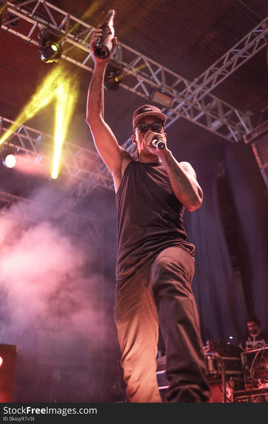 Man Holding Microphone and Bottle