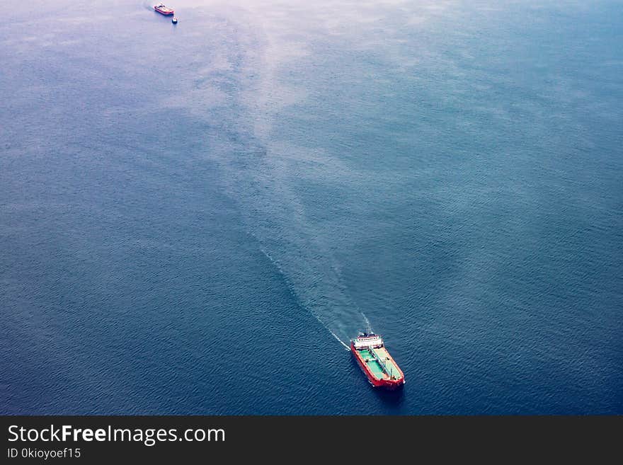 Red, White, and Teal Cargo Ship on Water