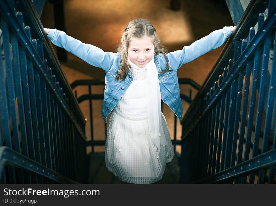 Girl Wearing White Dress and Blue Denim Jacket Standing on Stairs