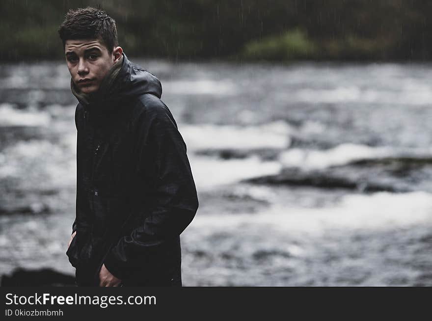 Man Wearing Black Rain Coat