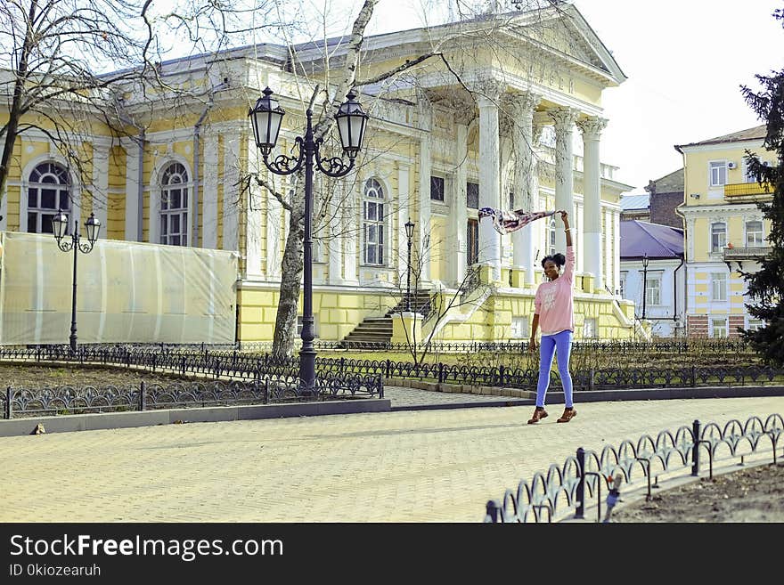 Girl Wearing Pink Long-sleeved Shirt and Blue Pants at Street