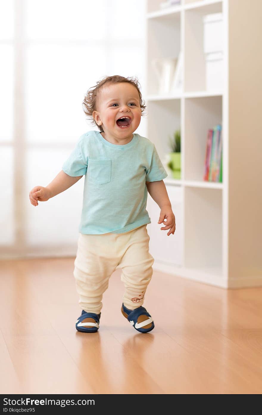 Little baby boy running and laughing in ther living room