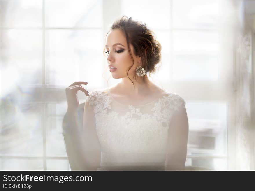 Young Beautiful Brunette Woman With Bouquet Posing In A Wedding