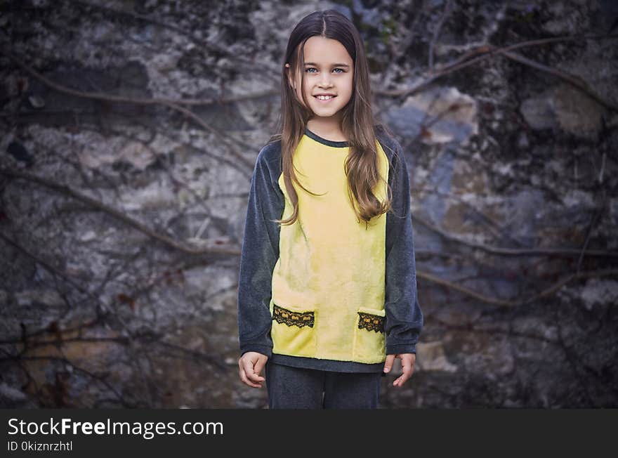 Portrait of brunette teenager female over grey rock. Portrait of brunette teenager female over grey rock.