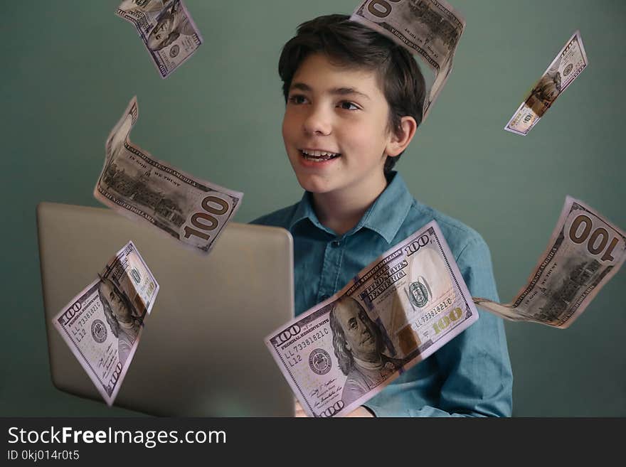 Talented successful ambitious teenager boy with laptop freelance working earn money on internet