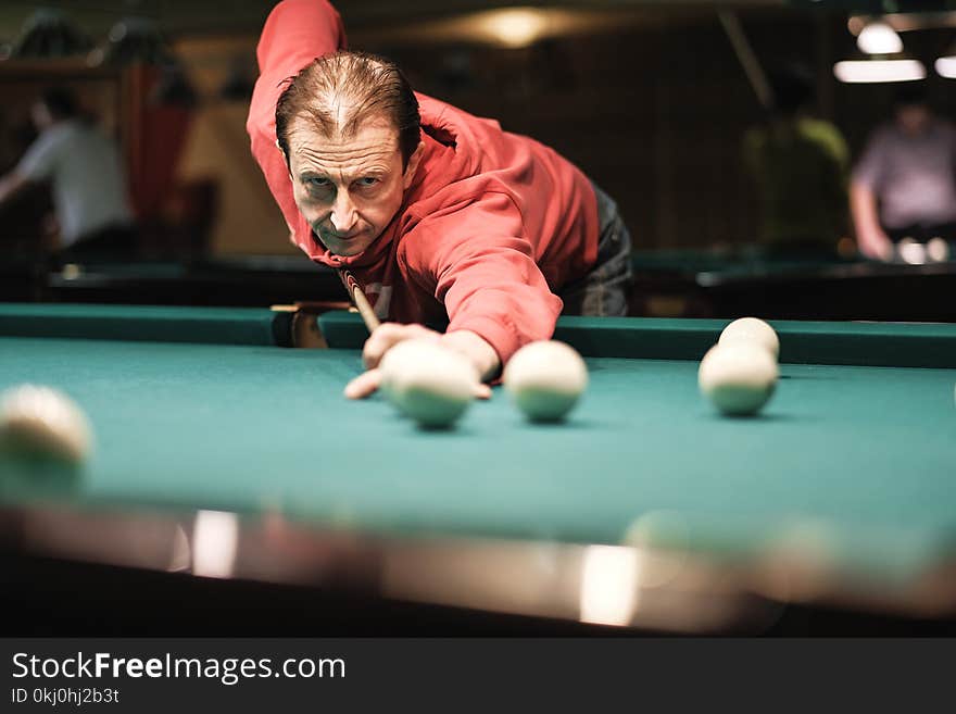 Billiards player plays Billiards aiming at the ball. Billiards player plays Billiards aiming at the ball