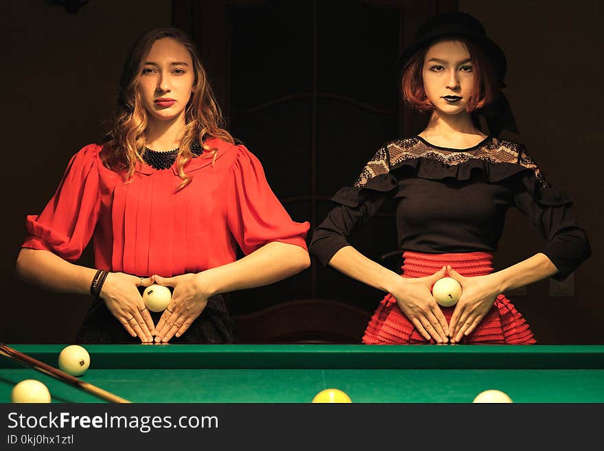 Two beautiful girls in the billiard room. Two beautiful girls in the billiard room