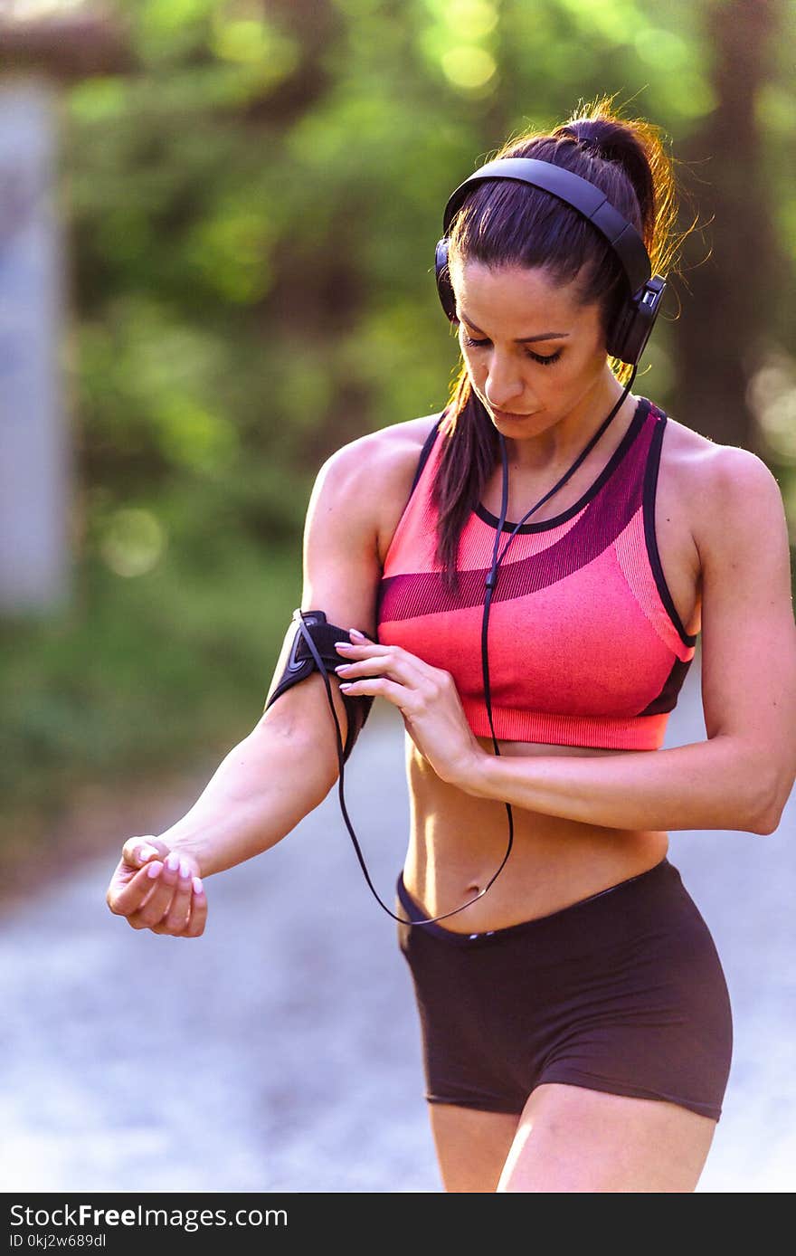 Young Fitness Woman Listening Music During Workout In In The Park