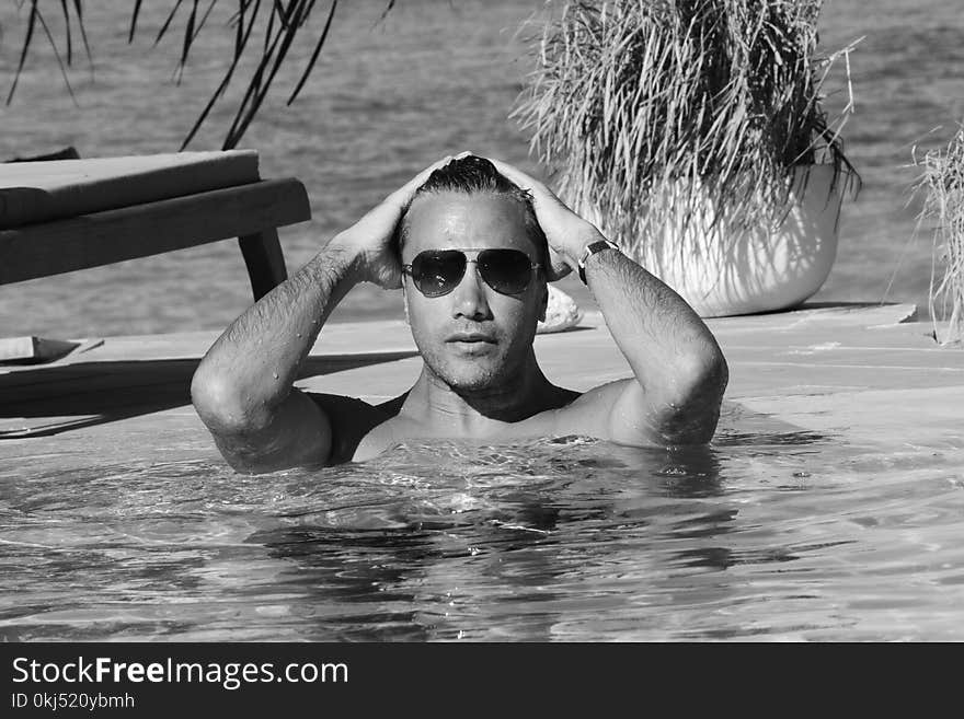 Grayscale Photo Of Man In Swimming Pool