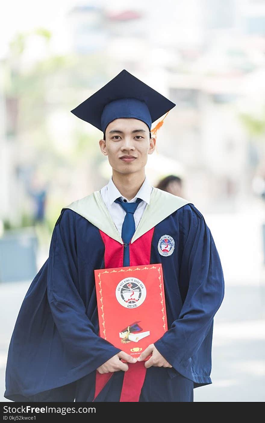 Man In Toga Holding Diploma